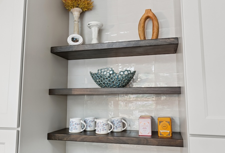built-in shelving with coffee mugs and home accents