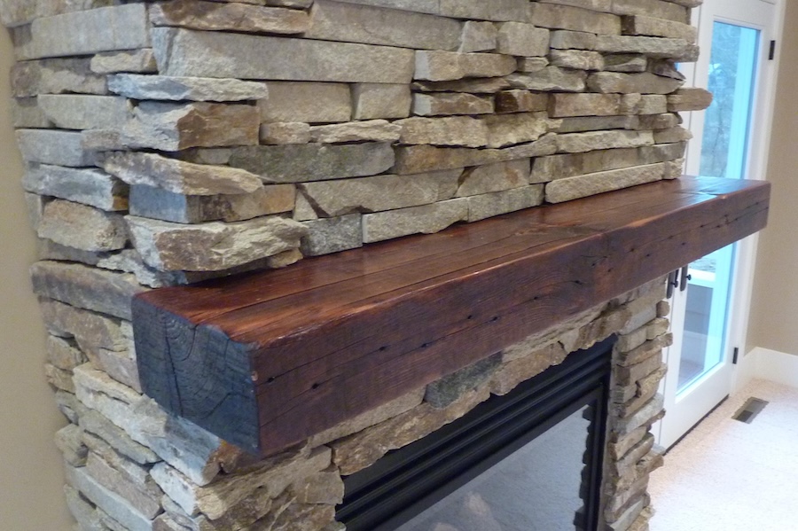 wood mantle on stone fireplace