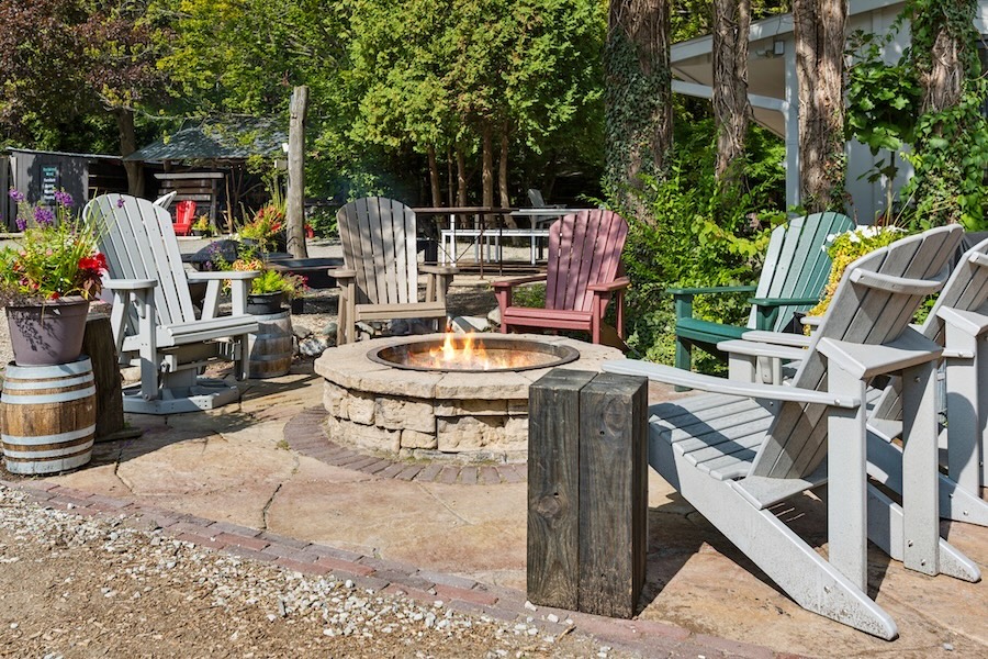 Adirondack chairs and gliders around firepit