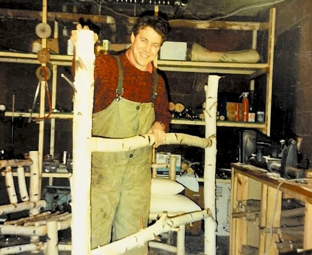 Andy holding bed frame over 30 years ago