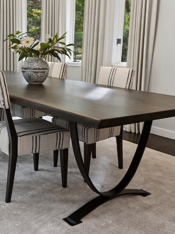Dining table with arced iron base