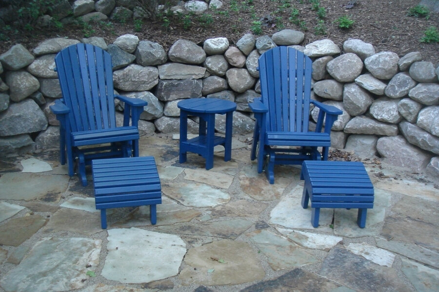 two blue adirondack gliders, ottomans, and round side table