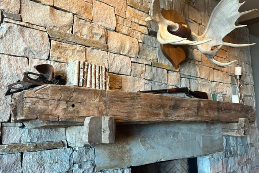 Beam fireplace mantle on stone hearth