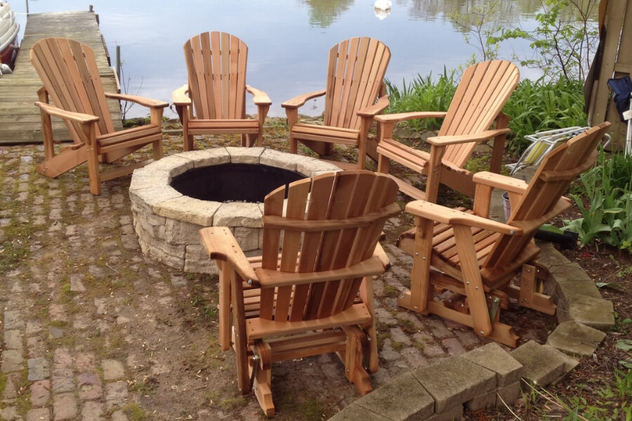 4 adirondack chairs and 2 adirondack gliders around firepit